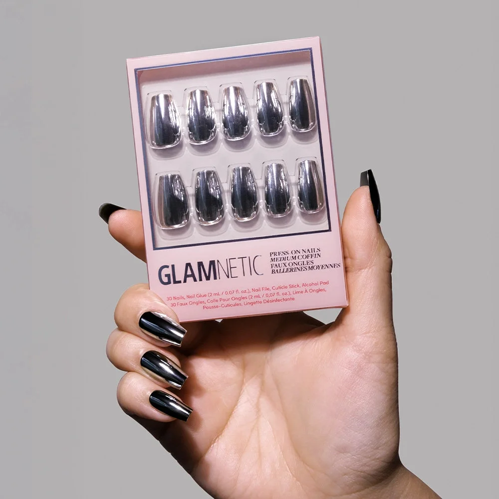 Hand holding a Glamnetic Gunmetal press-on nail kit.
